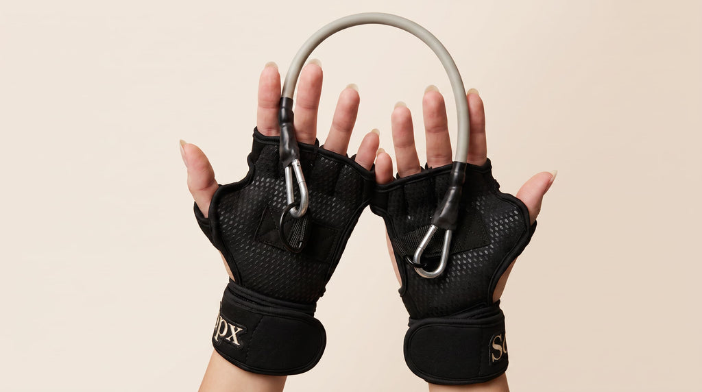 workout glove and resistance band set on female hands