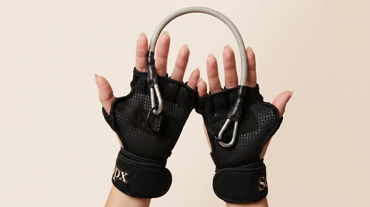 workout glove and resistance band set on female hands